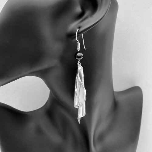 Designer silver scroll drop earrings.