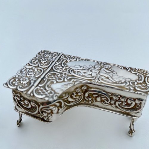 Miniature embossed silver baby grand style piano box.