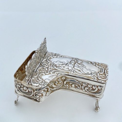 Miniature embossed silver baby grand style piano box.