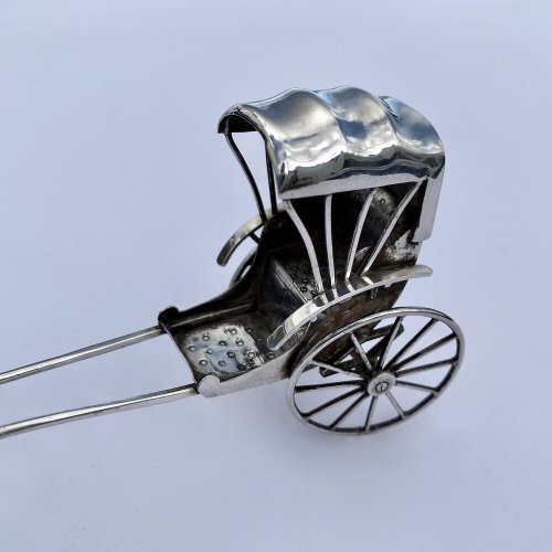 Miniature antique oriental rickshaw.