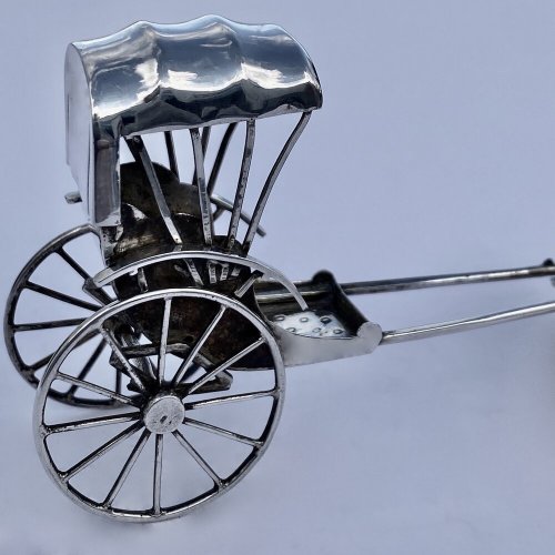 Miniature antique oriental rickshaw.