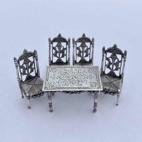 Miniature silver set table and chairs.