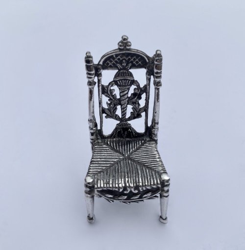 Miniature silver set table and chairs.