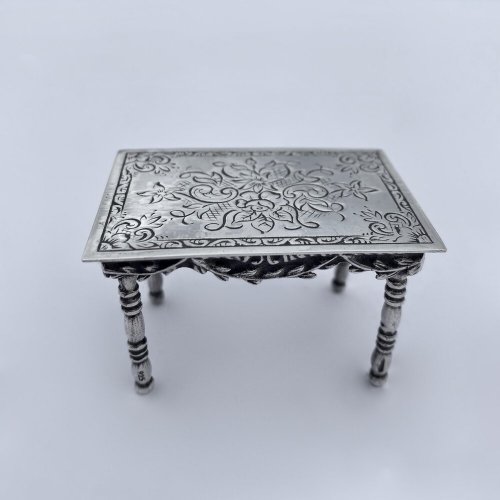 Miniature silver set table and chairs.