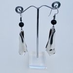 Designer silver scroll drop earrings.