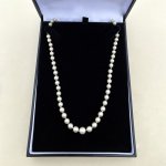 Necklace of graduated cultured pearls.